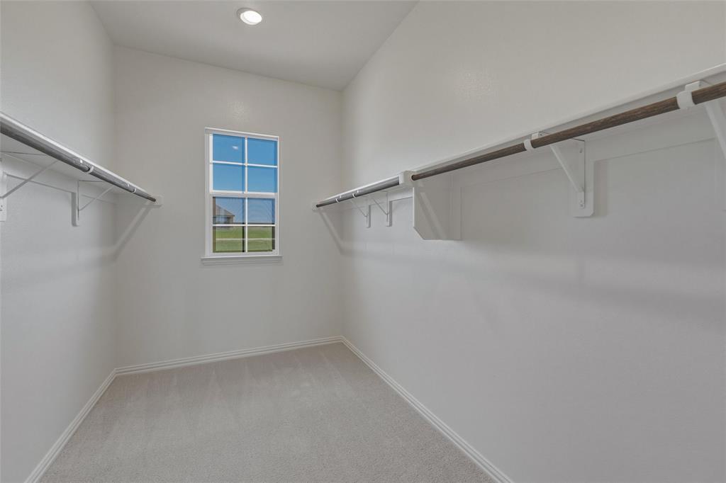 136 Hillview Trail Decatur, TX 76234 - Photo 15 of 26 Recessed lighting, light gray carpeting, window with gridded panes, two hanging rods, and built-in shelving