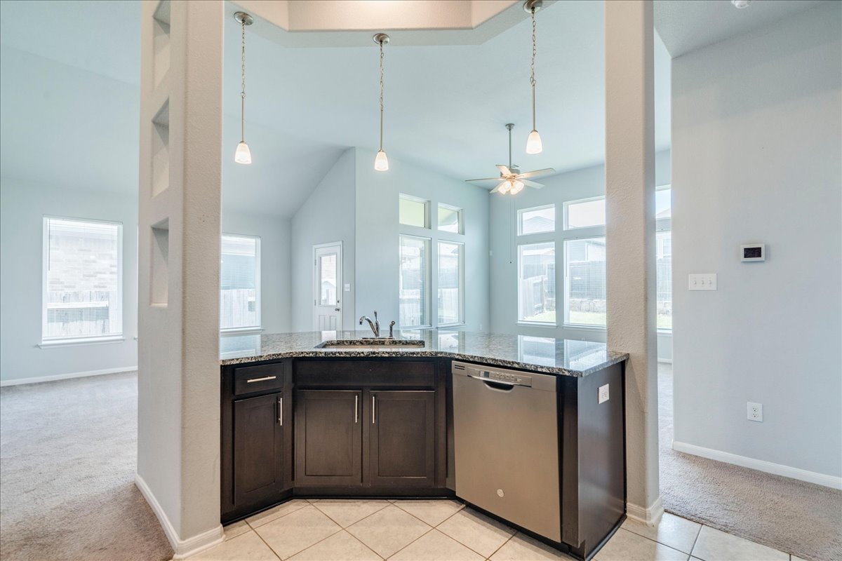 275 Cherrystone Loop Buda, TX 78610 - Photo 10 of 33 Large kitchen featuring granite countertops, espresso cabinets, stainless appliances and tons of counter and cabinet space.