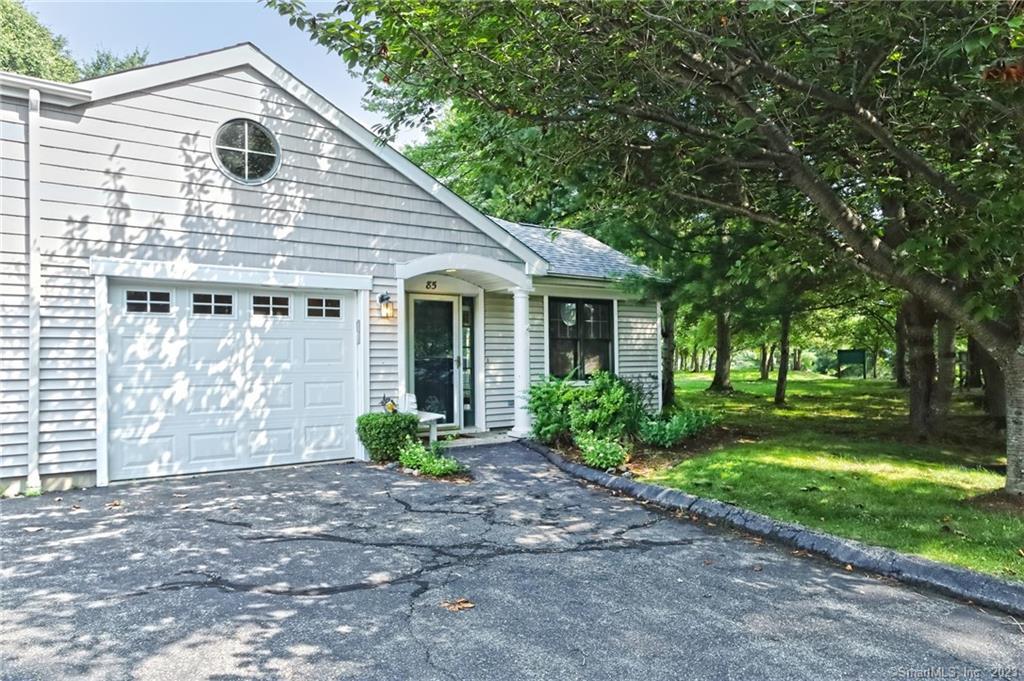 85 Red Cedar Circle, Unit 85 Orange, CT 06477 - Photo 1 of 1 a front view of a house with garden