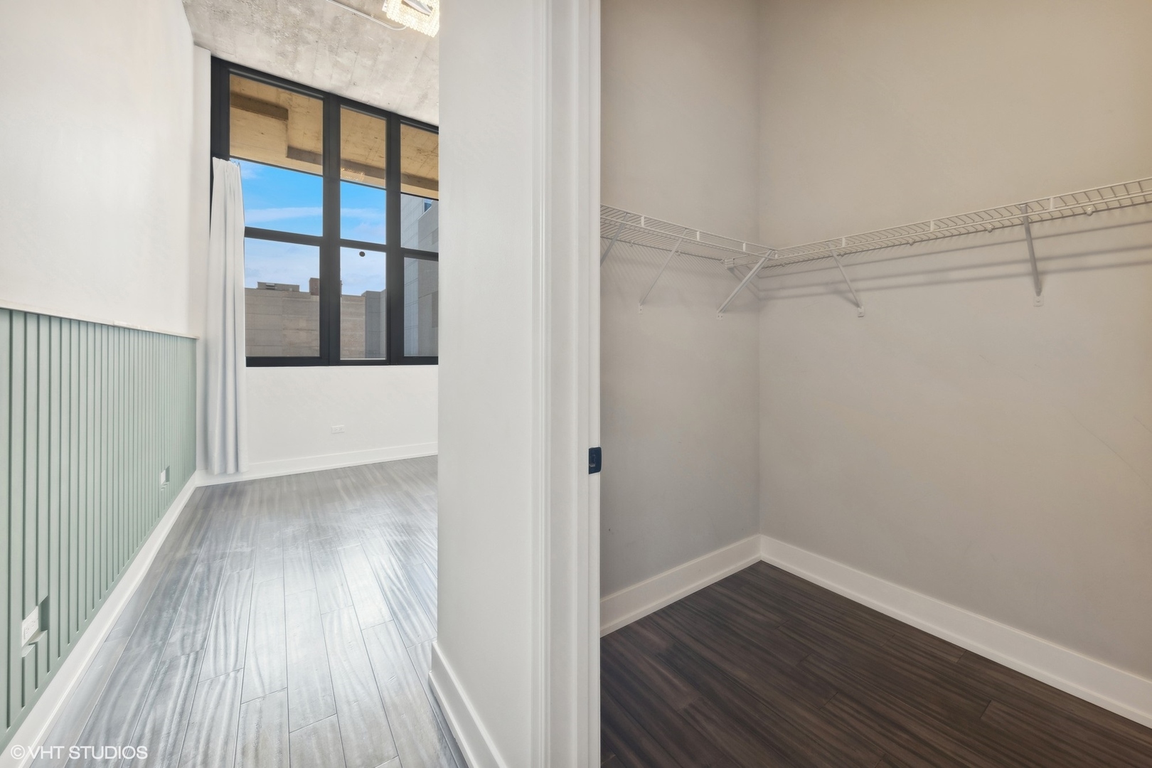 320 East 21st Street, Unit 215 Chicago, IL 60616 - Photo 11 of 25 a view of an empty room with wooden floor and a window