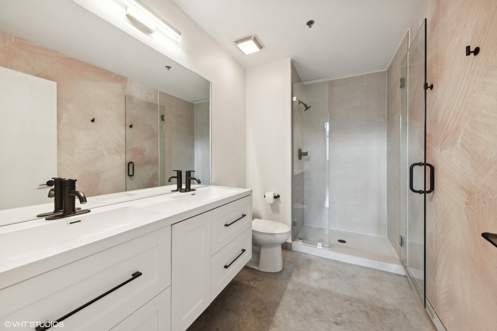 320 East 21st Street, Unit 215 Chicago, IL 60616 - Photo 14 of 25 a bathroom with a double vanity sink toilet mirror and shower