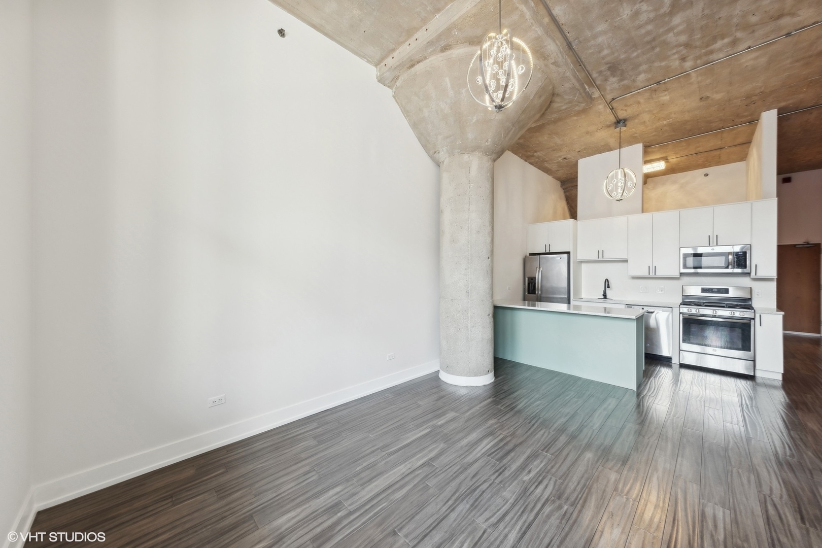 320 East 21st Street, Unit 215 Chicago, IL 60616 - Photo 6 of 25 a view of a kitchen with wooden floor and stainless steel appliances
