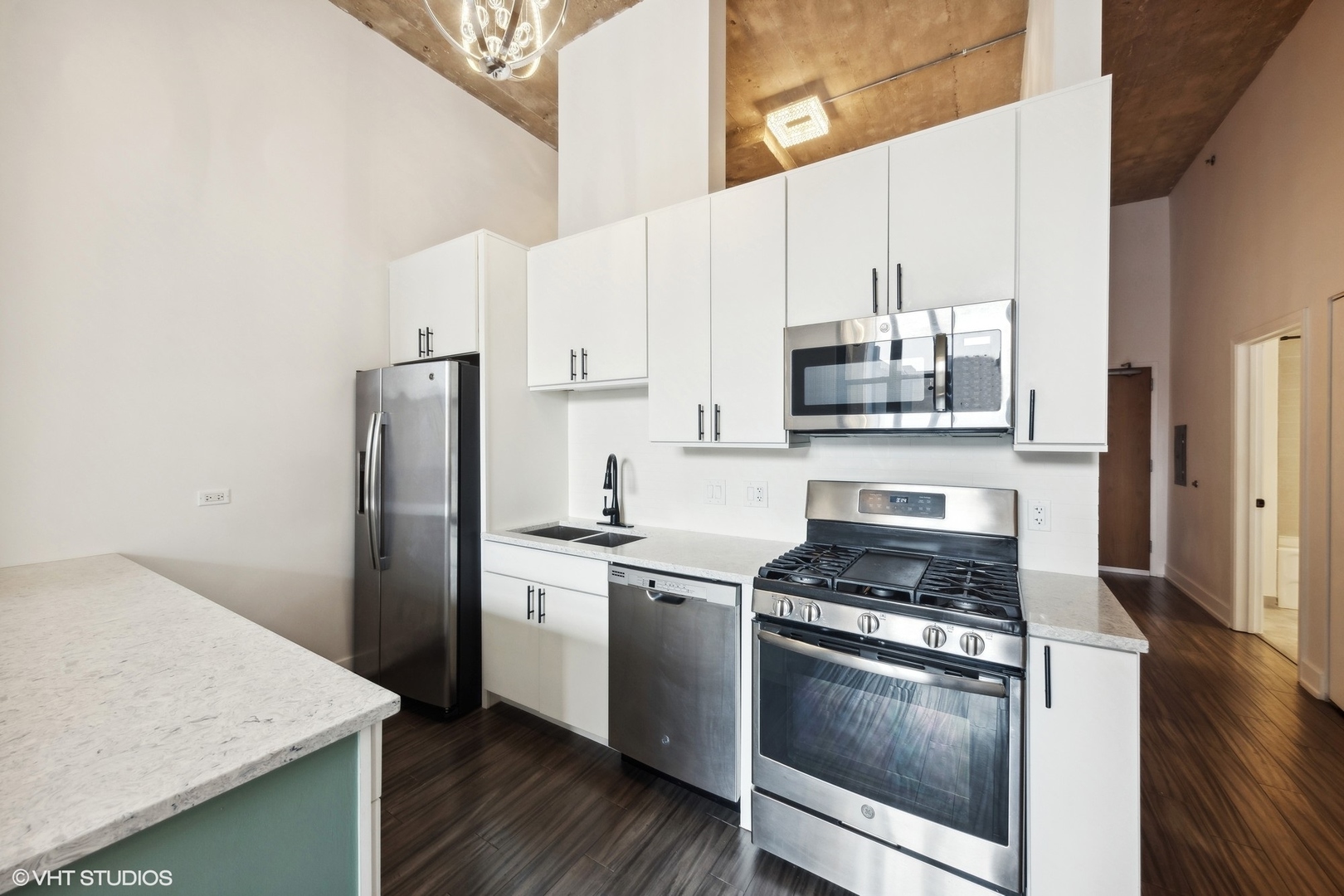 320 East 21st Street, Unit 215 Chicago, IL 60616 - Photo 8 of 25 a kitchen with stainless steel appliances and wooden cabinets