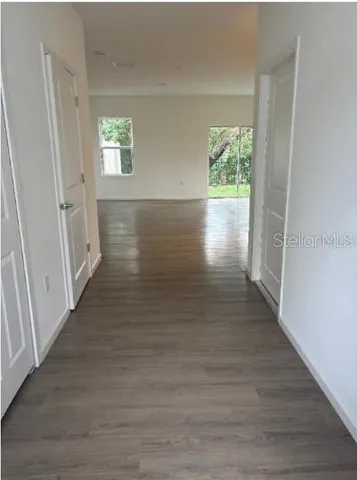 a view of hallway with wooden floor