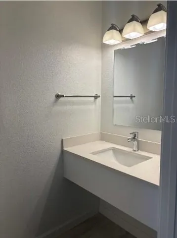 a bathroom with a sink and a mirror