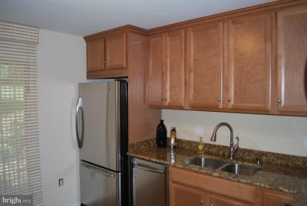 12140 Quorn Lane Reston, VA 20191 - Photo 3 of 6 a kitchen with a refrigerator and cabinets