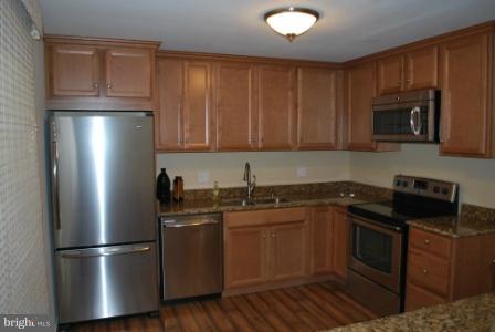 12140 Quorn Lane Reston, VA 20191 - Photo 5 of 6 a kitchen with a sink stove and refrigerator