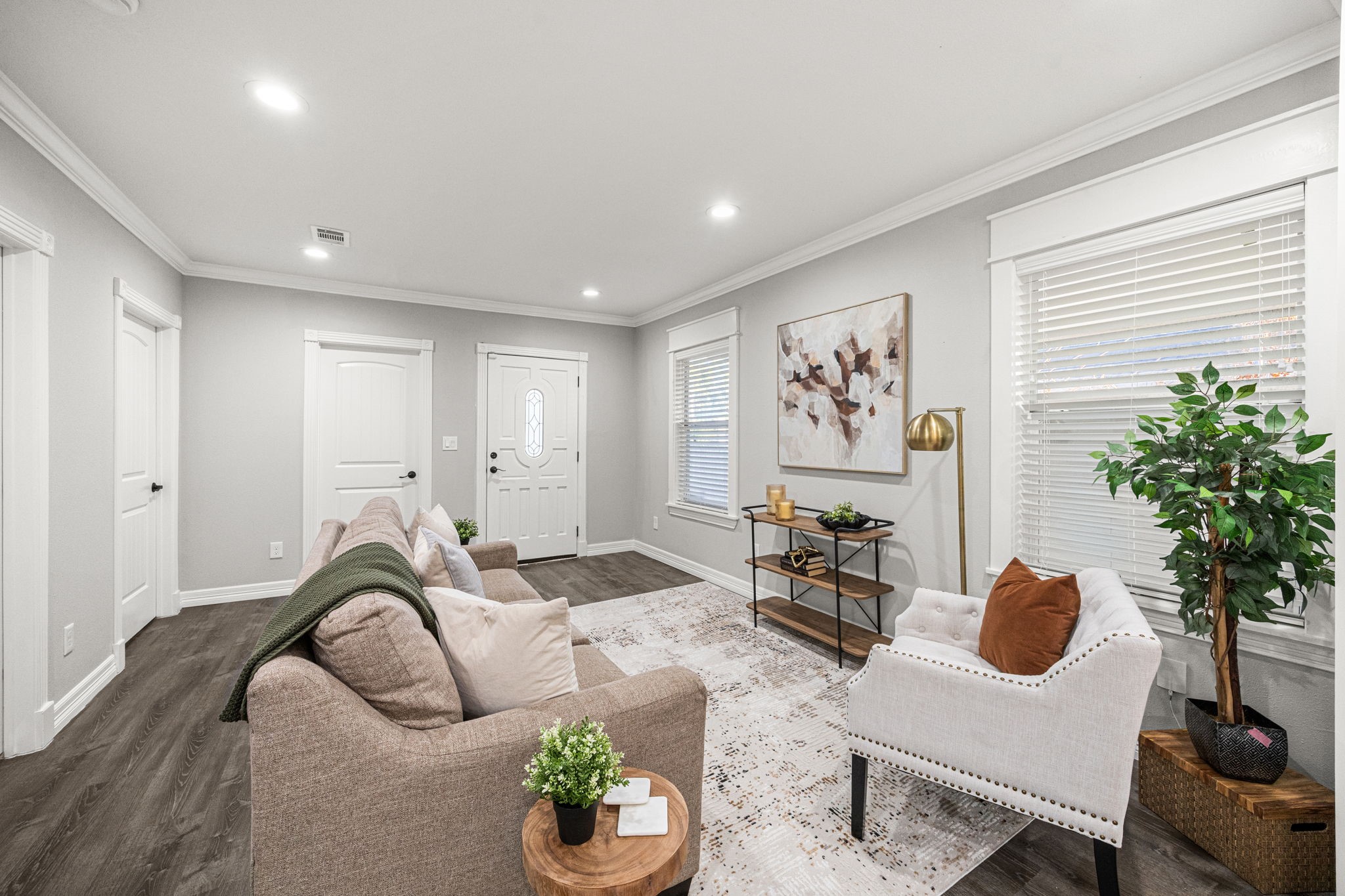 1405 Walton Street Houston, TX 77009 - Photo 6 of 28 Inviting main living space with expansive windows, elegant crown molding, and warm flooring that ties the room together while maintaining an airy, open feel.