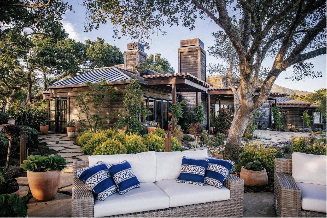 46820 Clear Ridge Road Big Sur, CA 93920 - Photo 12 of 26 a view of a patio with couches table and chairs and potted plants