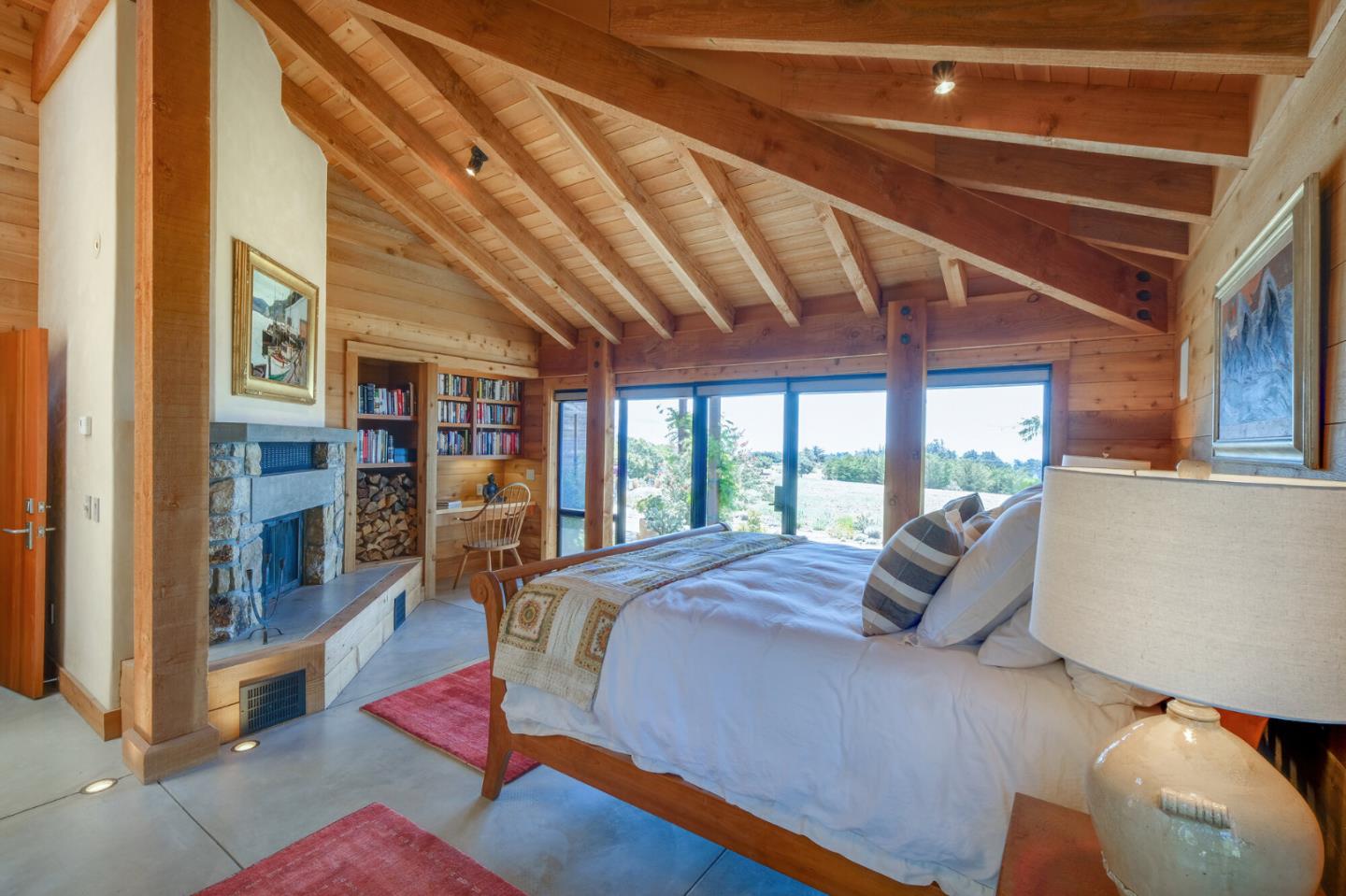 46820 Clear Ridge Road Big Sur, CA 93920 - Photo 18 of 26 a large bedroom with a bed and large window
