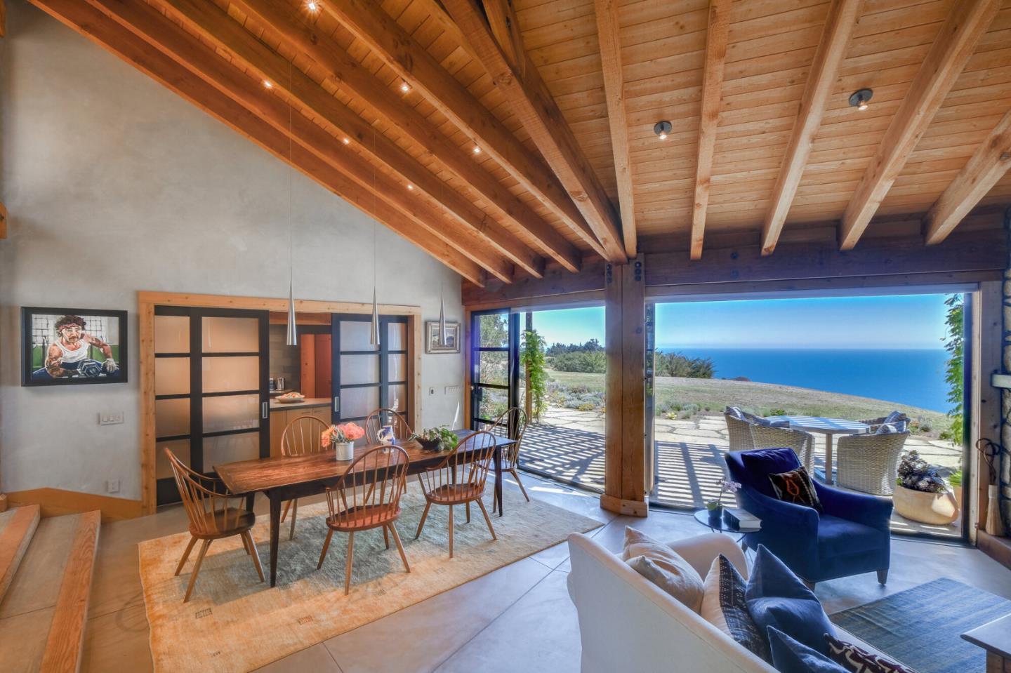 46820 Clear Ridge Road Big Sur, CA 93920 - Photo 3 of 26 a view of a dining room with furniture large windows and wooden floor