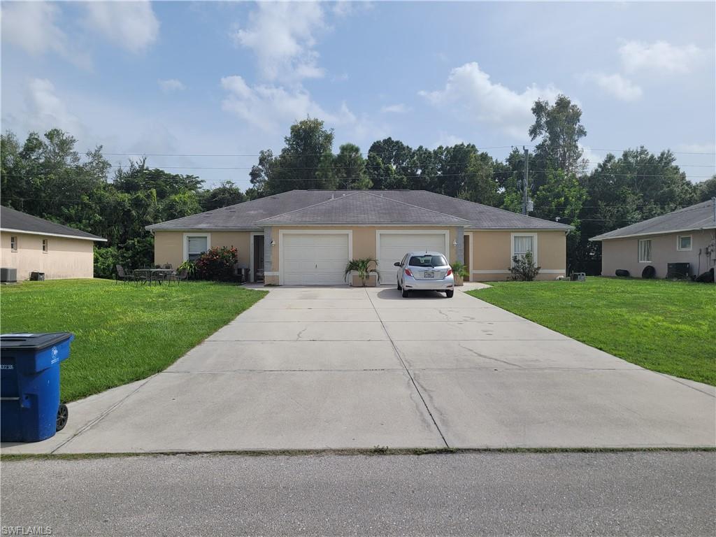 8352 Matanzas Road Fort Myers, FL 33967 - Photo 1 of 4 a car parked in front of house with a yard