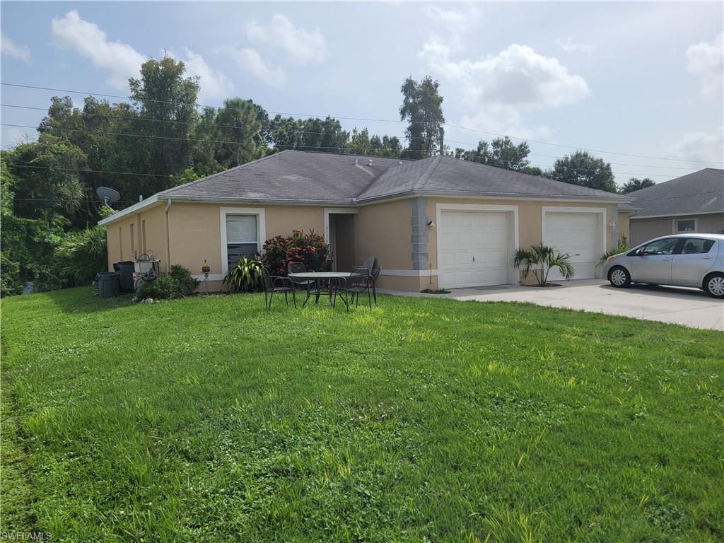 8352 Matanzas Road Fort Myers, FL 33967 - Photo 2 of 4 a front view of house with yard and green space