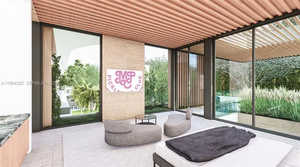 a living room with patio furniture and a garden