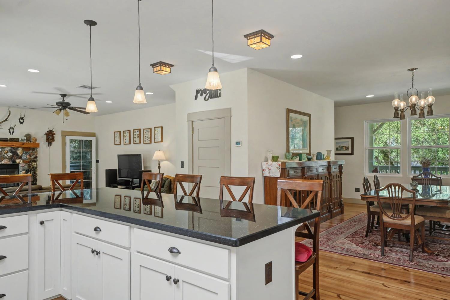 14232 Sutter Creek Road Sutter Creek, CA 95685 - Photo 18 of 57 a kitchen with center island table and chairs in it