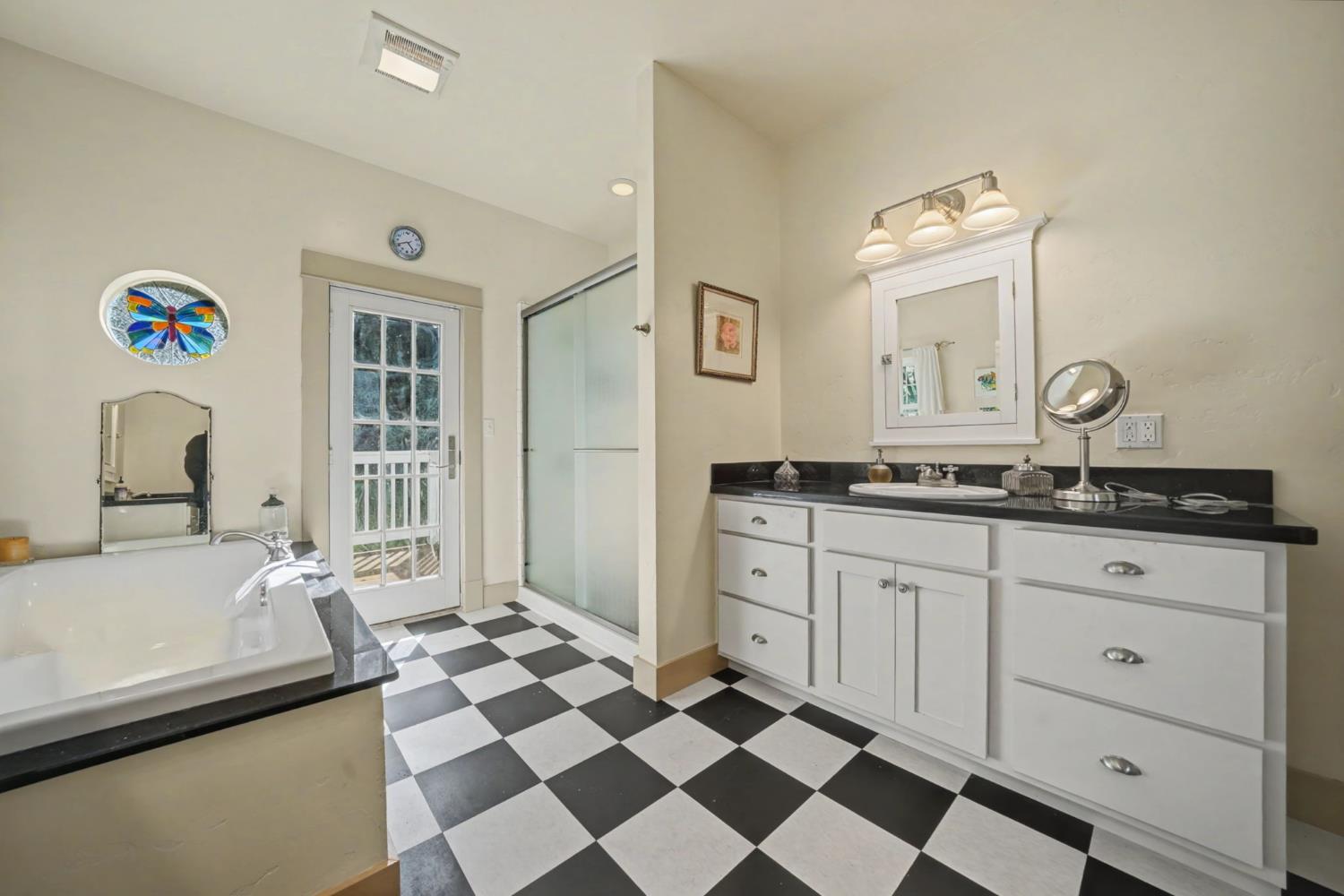 14232 Sutter Creek Road Sutter Creek, CA 95685 - Photo 40 of 57 a spacious bathroom with a granite countertop sink and a mirror