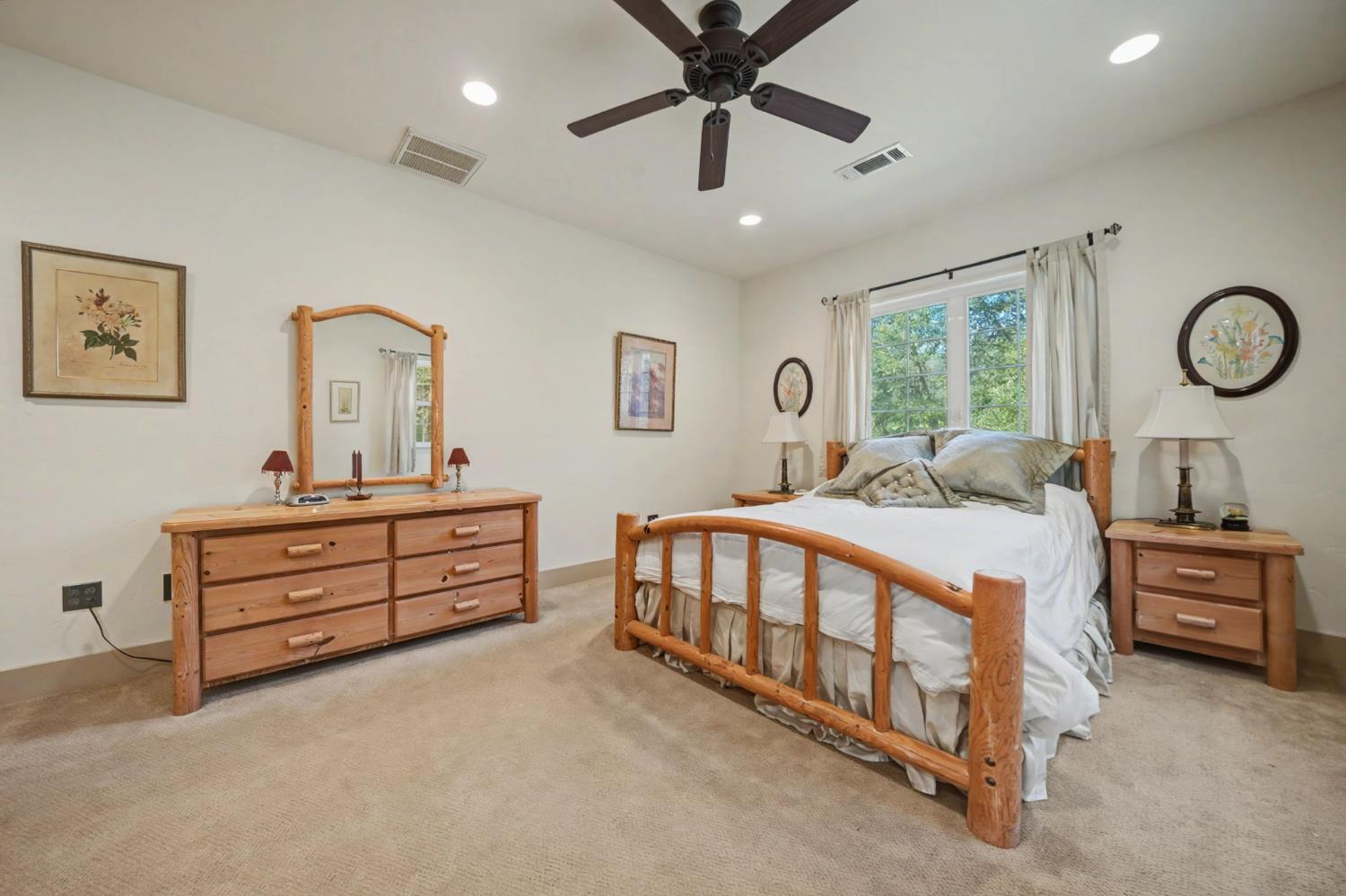 14232 Sutter Creek Road Sutter Creek, CA 95685 - Photo 42 of 57 a bedroom with a bed and a chandelier