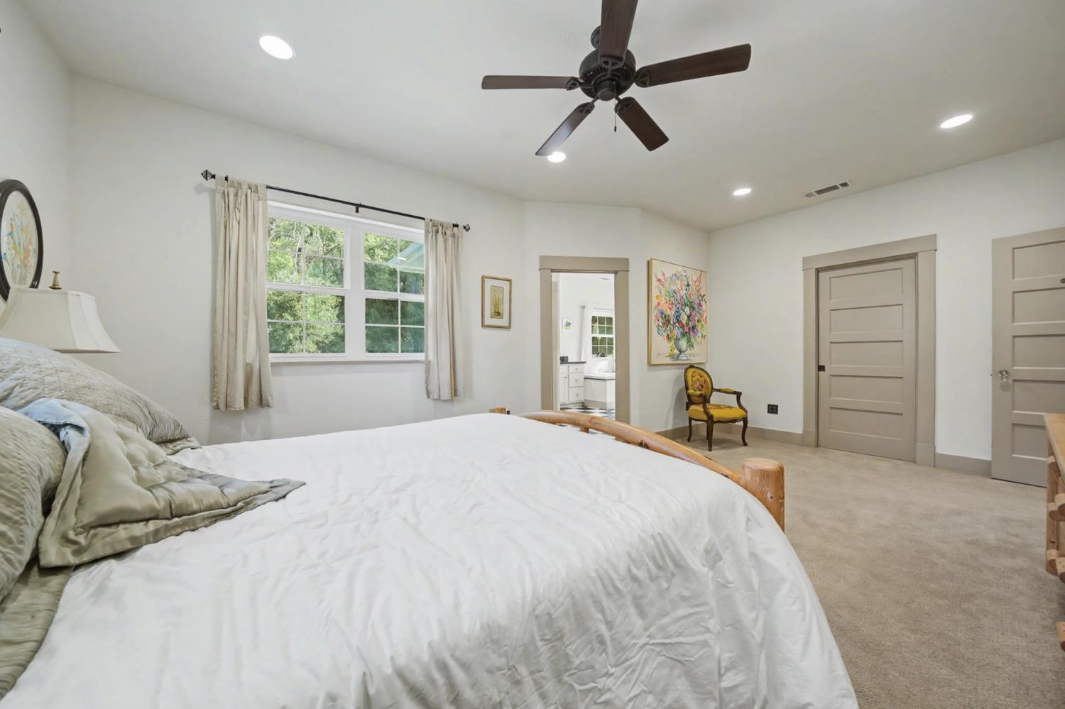 14232 Sutter Creek Road Sutter Creek, CA 95685 - Photo 44 of 57 a spacious bedroom with a bed a dresser and a window