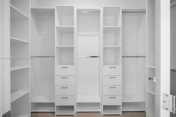 a bathroom with a double vanity sink a mirror and shower