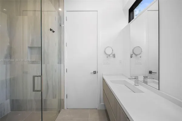 a bathroom with a double vanity sink and mirror