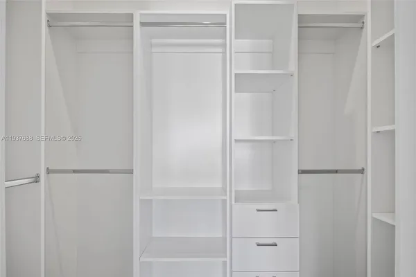 a bathroom with a shower sink vanity and toilet