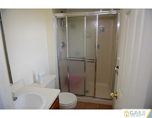 56 Meyer Road Edison, NJ 08817 - Photo 5 of 24 a bathroom with a sink and a mirror