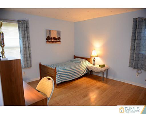 56 Meyer Road Edison, NJ 08817 - Photo 8 of 24 a bedroom with furniture and a window