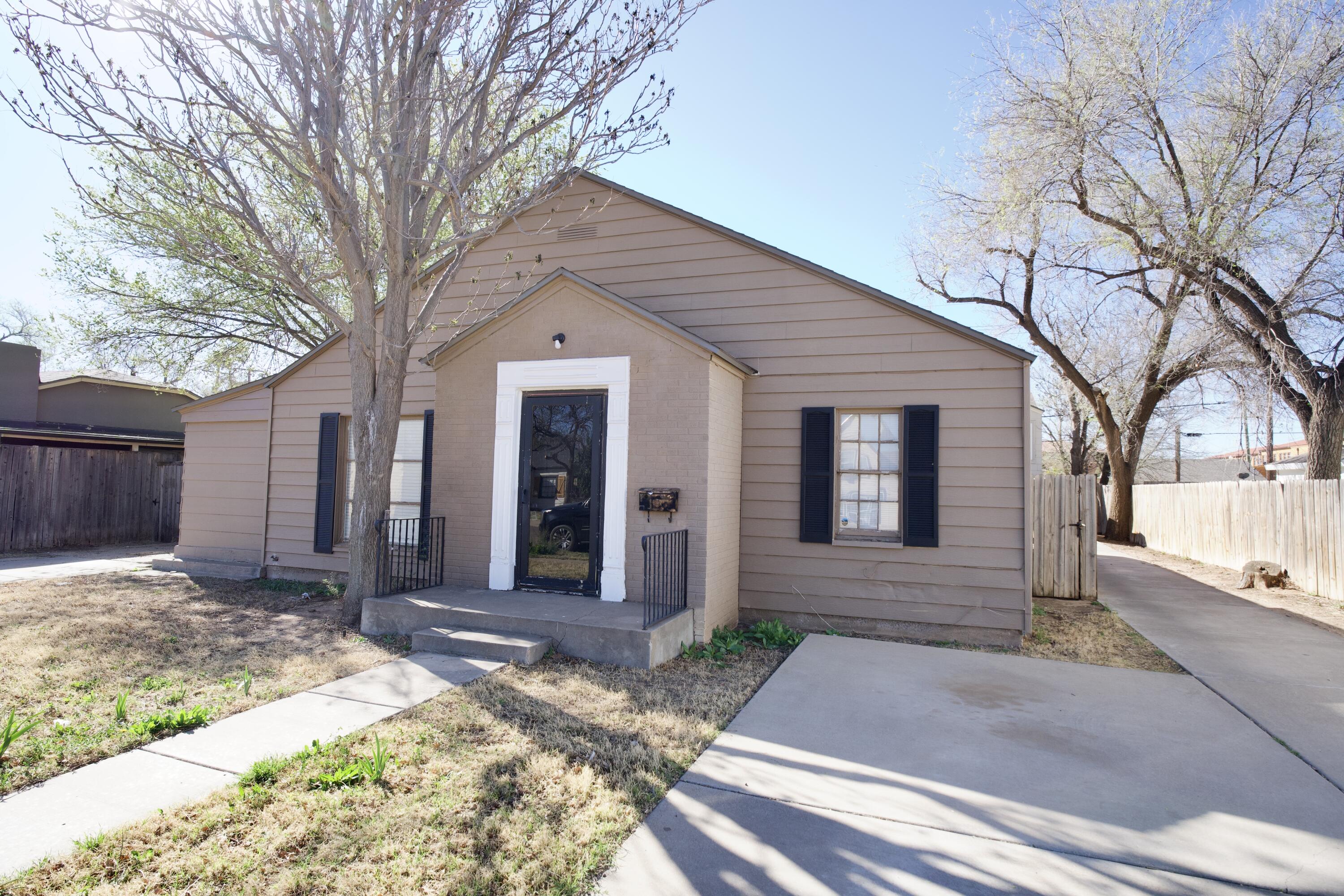 1919 17th Street Lubbock, TX 79401 - Photo 1 of 13 a front view of a house with garden
