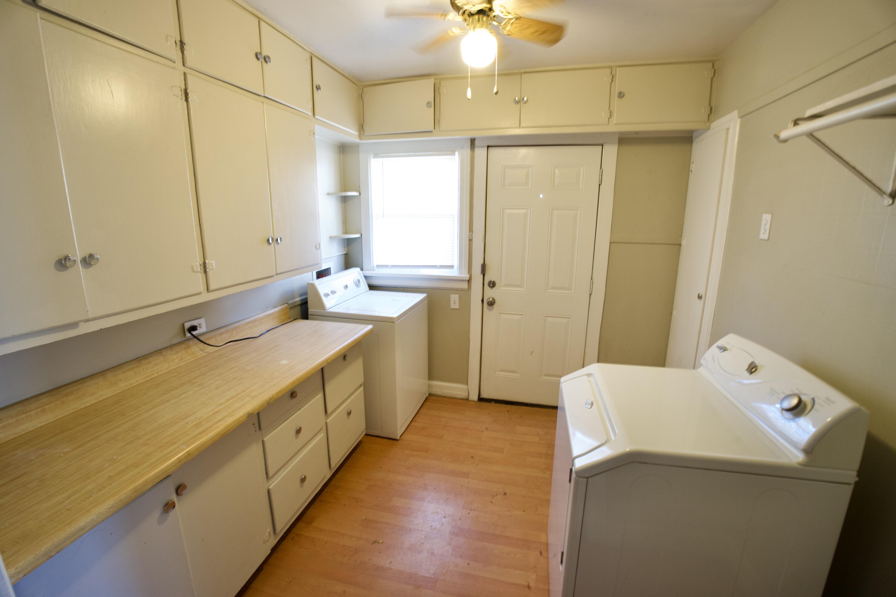 1919 17th Street Lubbock, TX 79401 - Photo 11 of 13 a bathroom with a double vanity sink and mirror with shower