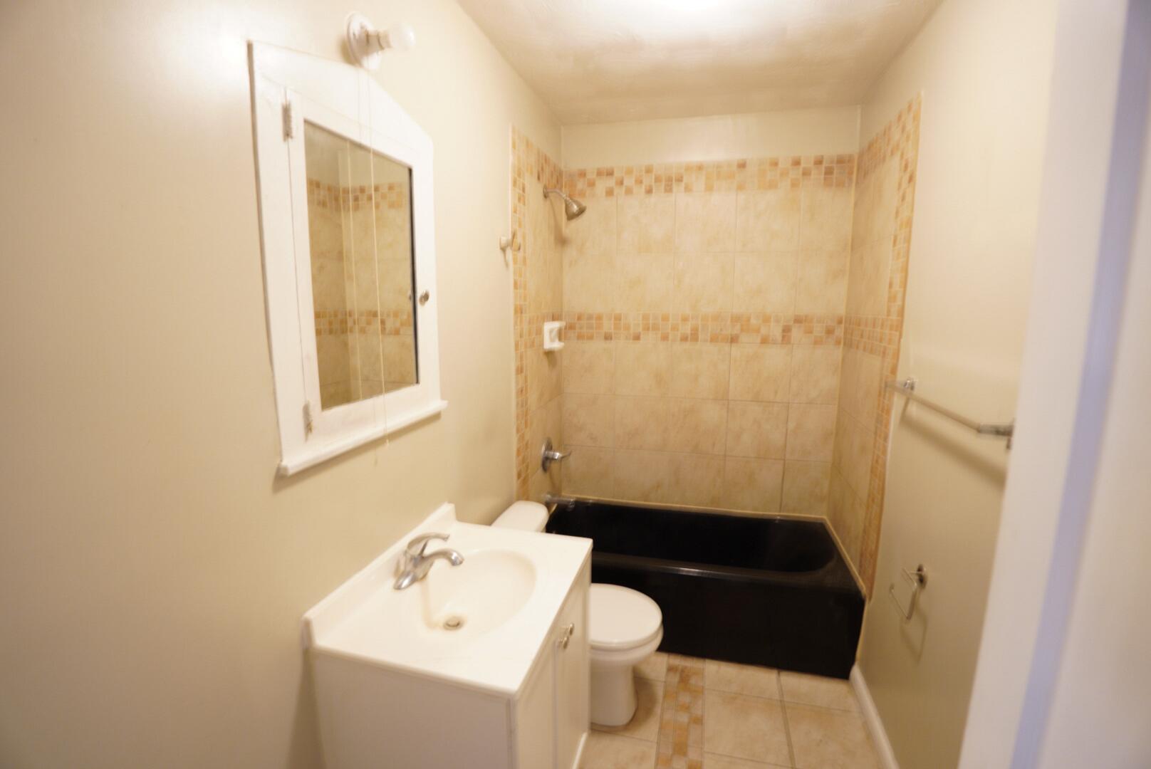 1919 17th Street Lubbock, TX 79401 - Photo 13 of 13 a bathroom with a sink a toilet and shower
