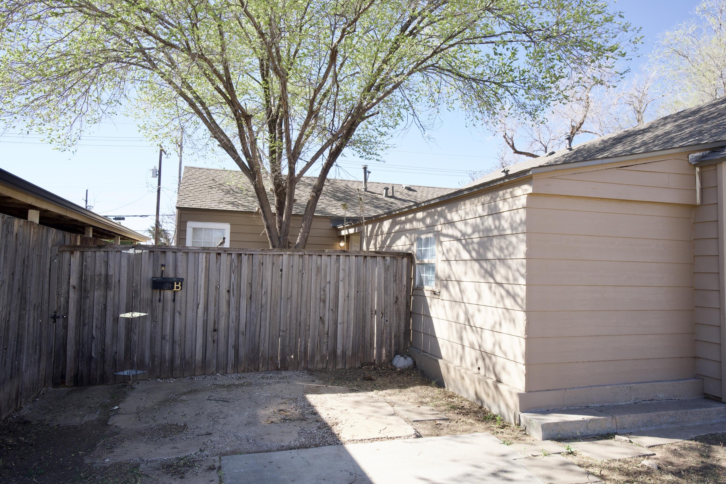 1919 17th Street Lubbock, TX 79401 - Photo 2 of 13 a view of backyard with a large tree