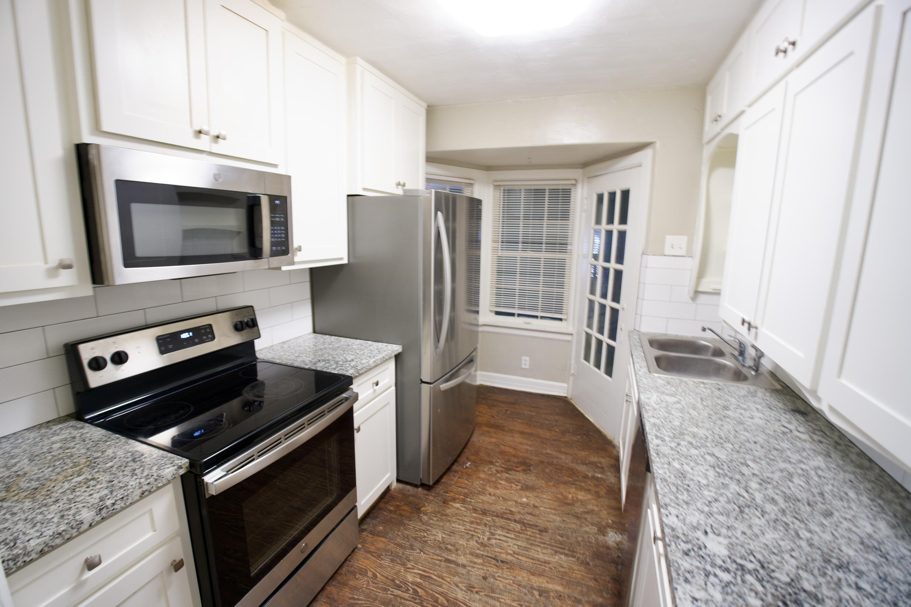 1919 17th Street Lubbock, TX 79401 - Photo 7 of 13 a kitchen with a stove and a microwave