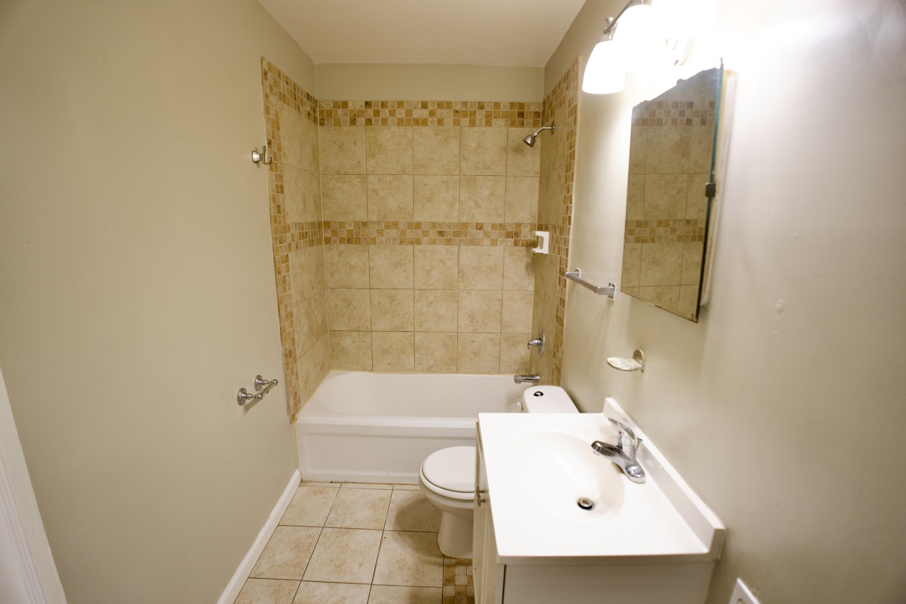 1919 17th Street Lubbock, TX 79401 - Photo 8 of 13 a bathroom with a sink a toilet and shower