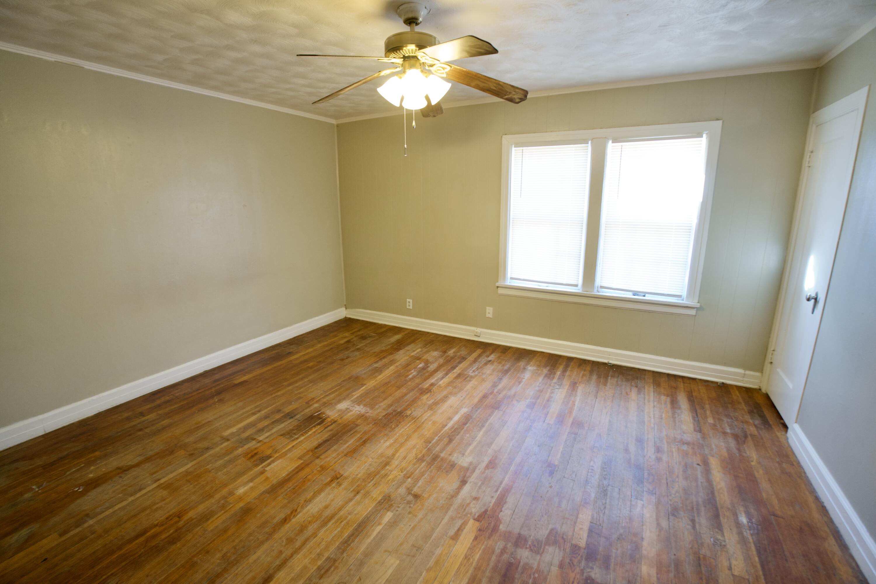 1919 17th Street Lubbock, TX 79401 - Photo 10 of 13 wooden floor in an empty room with a window