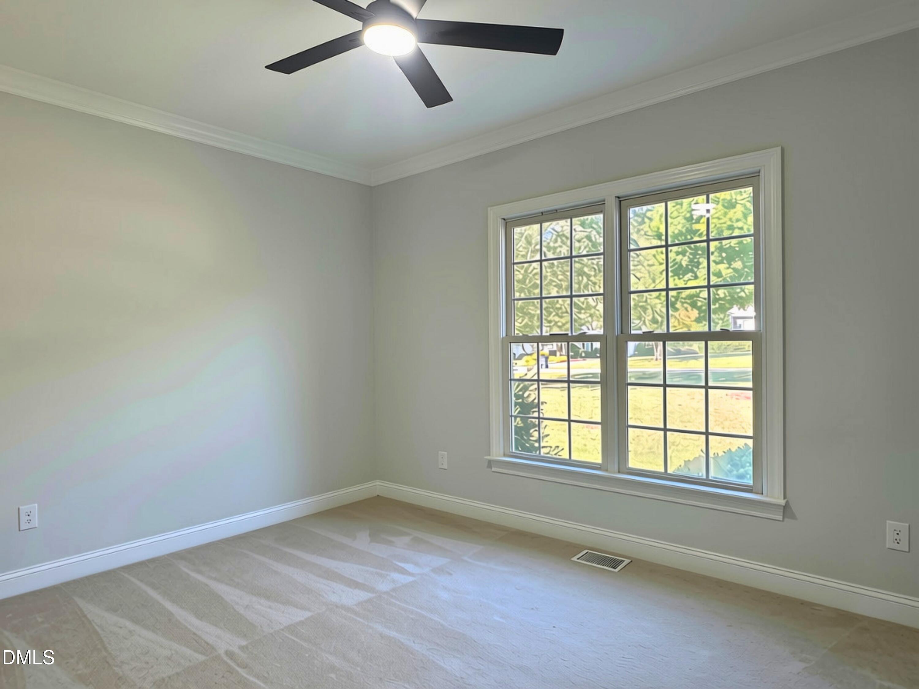 3100 Donlin Drive Wake Forest, NC 27587 - Photo 37 of 67 Neutral wall tones, crown molding, double-pane windows, and a ceiling fan with integrated lighting