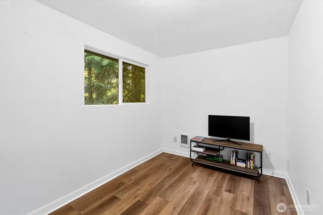 a room with wooden floor and a window