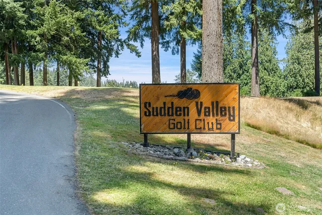 a sign board with a park bench