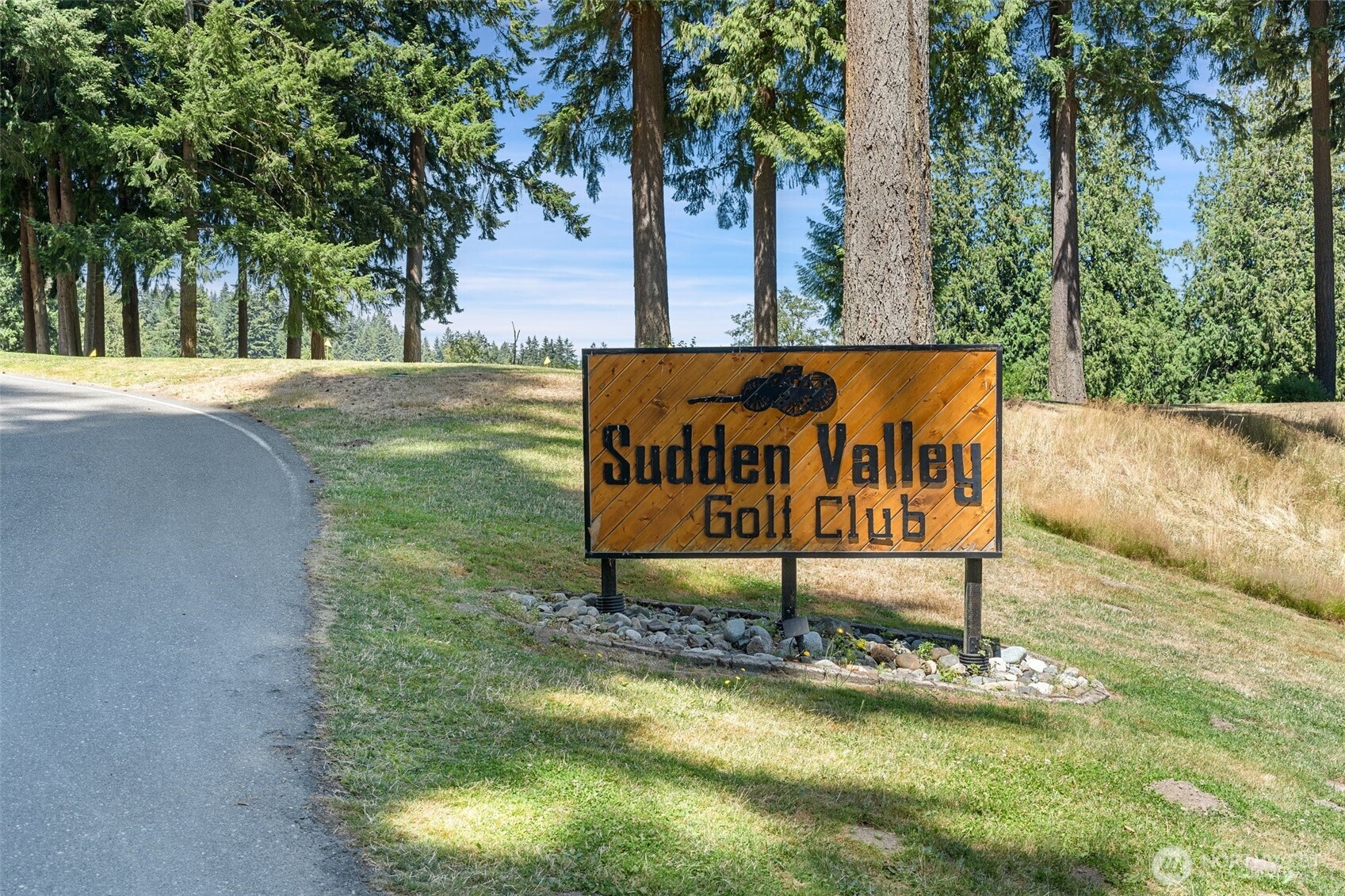 76 B Sudden Valley Drive Bellingham, WA 98229 - Photo 27 of 35 a sign board with a park bench