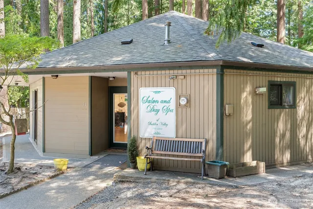 a view of a house with a wooden fence