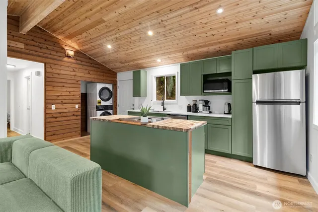 a kitchen with cabinets and a refrigerator