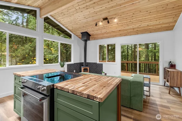 a view of a kitchen with kitchen island a large window in it