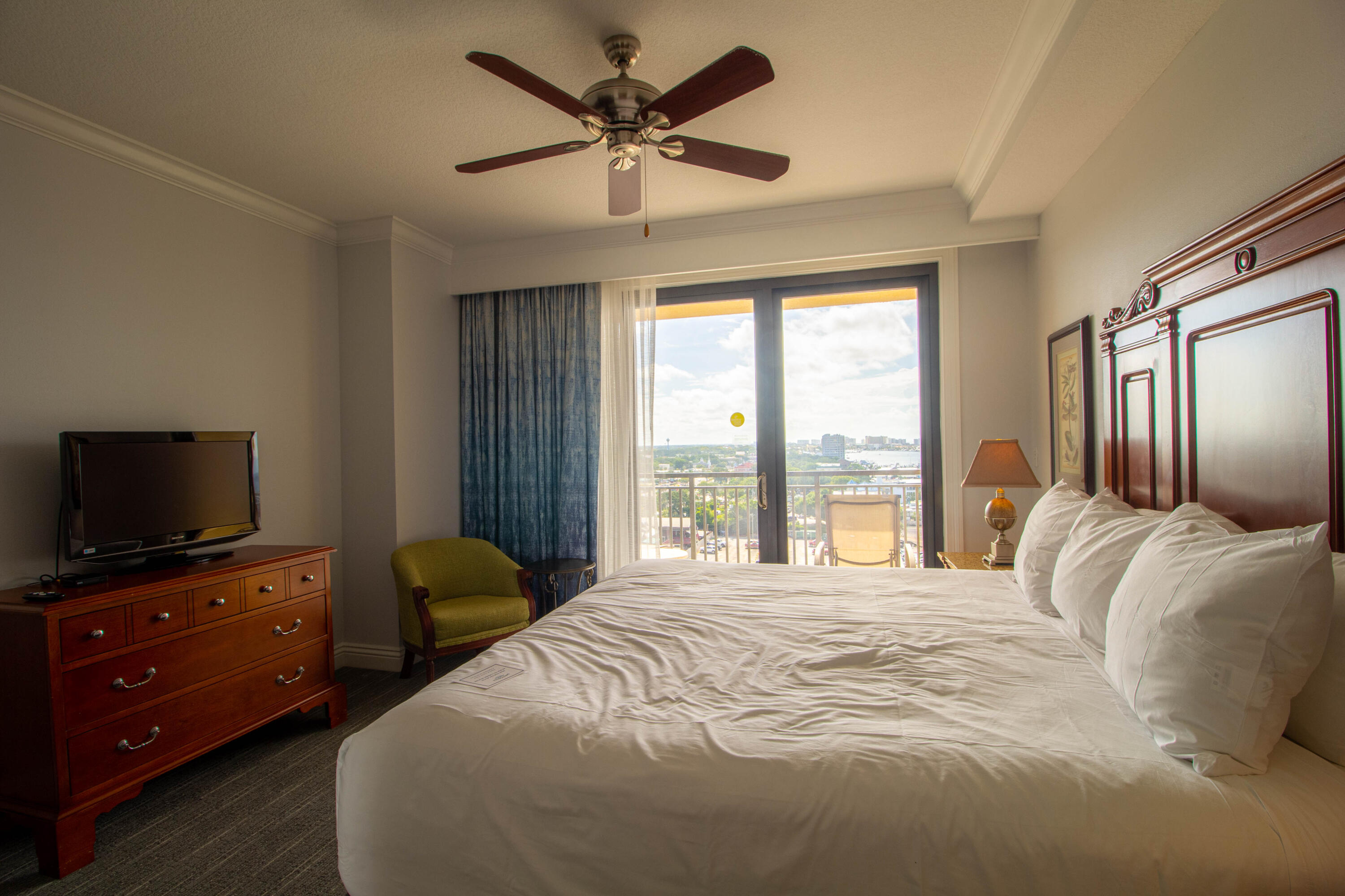 10 Harbor Boulevard, Unit E707H Destin, FL 32541 - Photo 17 of 28 a bedroom with a large bed and a flat tv screen on dresser
