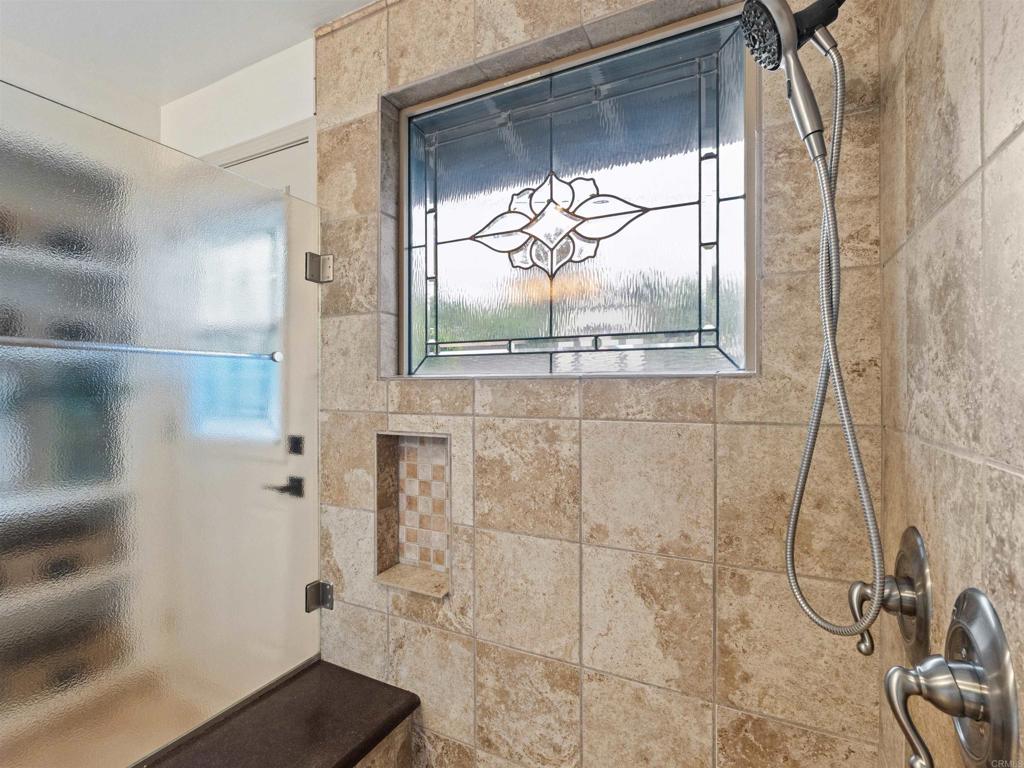 13737 Temple Street Poway, CA 92064 - Photo 21 of 38 a bathroom with a glass shower door