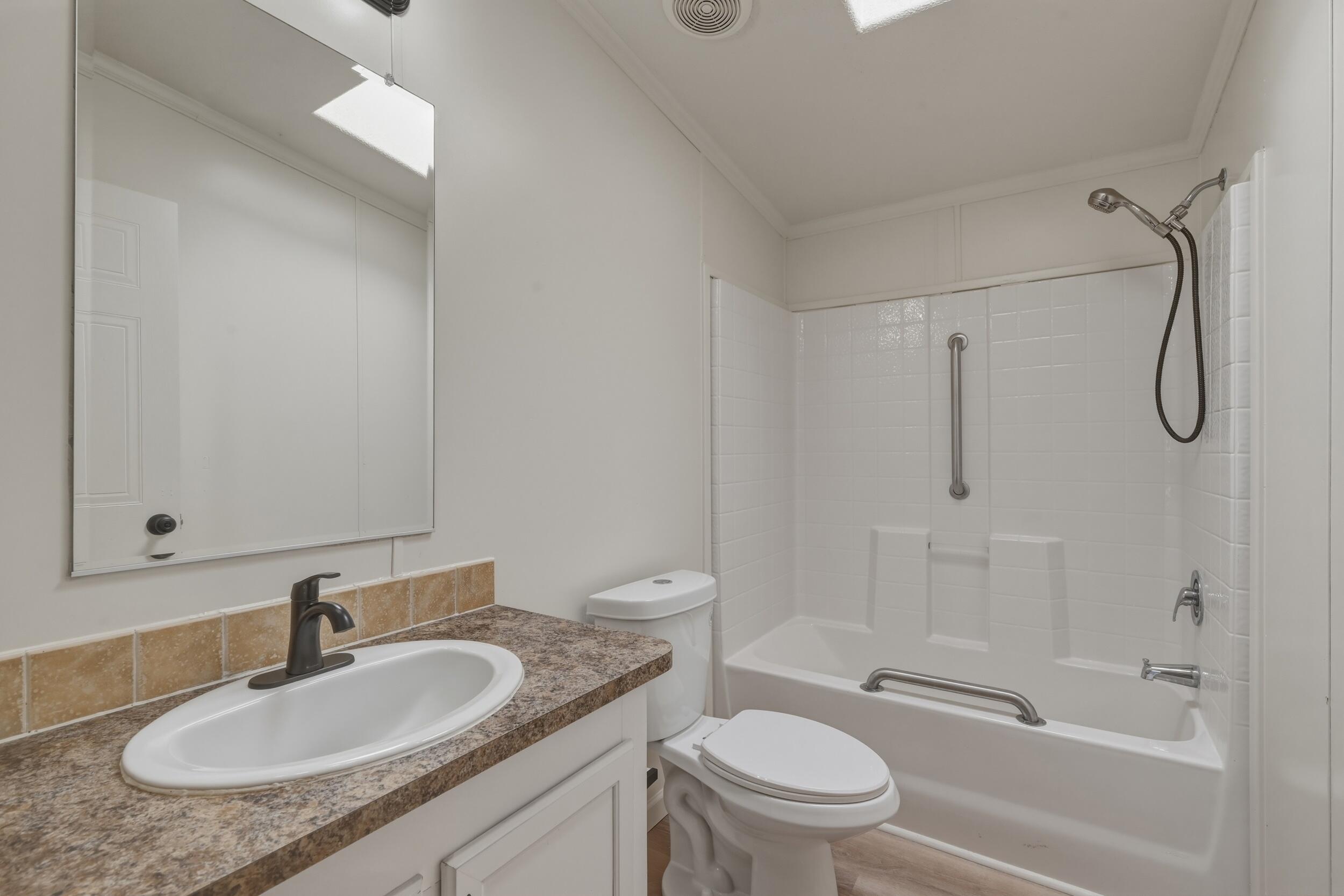 312 East Cedar Milll Road Star Valley, AZ 85541 - Photo 20 of 27 a bathroom with a granite countertop sink a toilet and shower