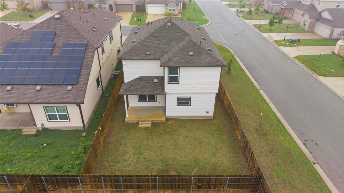 101 Rowdy Yates Way Jarrell, TX 76537 - Photo 31 of 32 Fenced backyard with concrete patio
