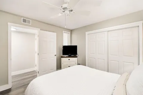 a bedroom with a bed and a flat tv screen