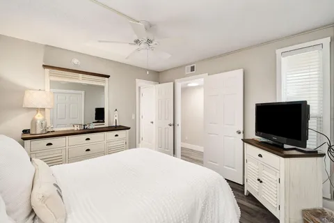 a room with a bed and a flat screen tv in it