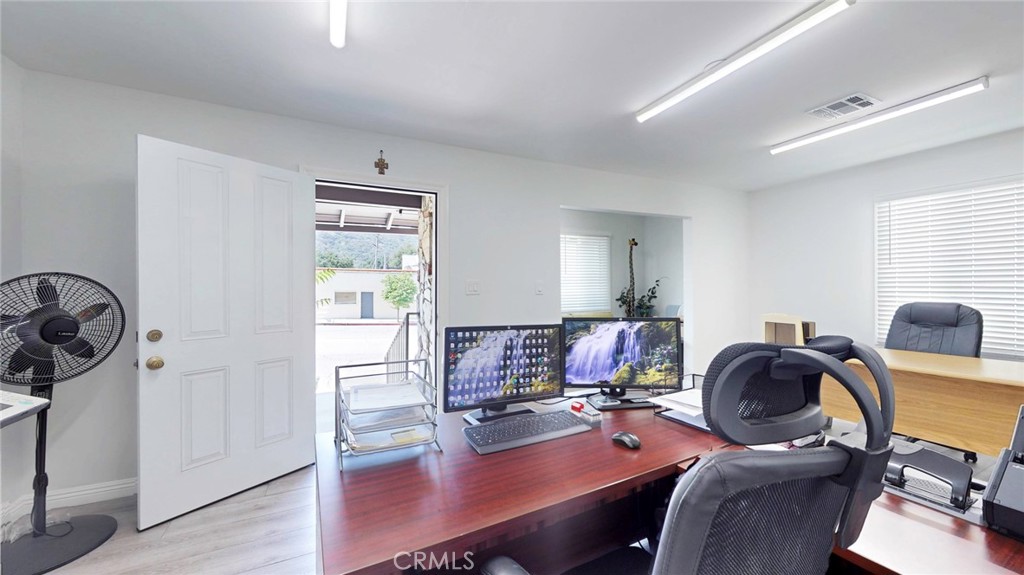 6851 Foothill Boulevard Tujunga, CA 91042 - Photo 11 of 50 a workspace with furniture and wooden floor