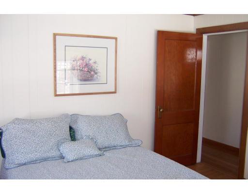 35 Benjamin Road Shirley, MA 01464 - Photo 11 of 13 a bedroom with a bed and a painting on the wall