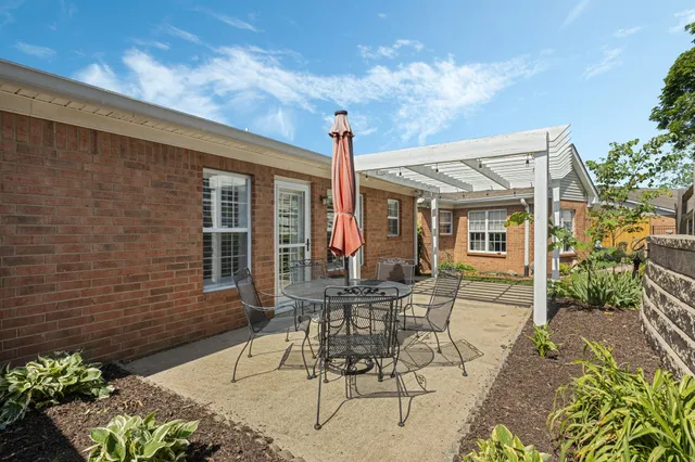 a view of a backyard with sitting area
